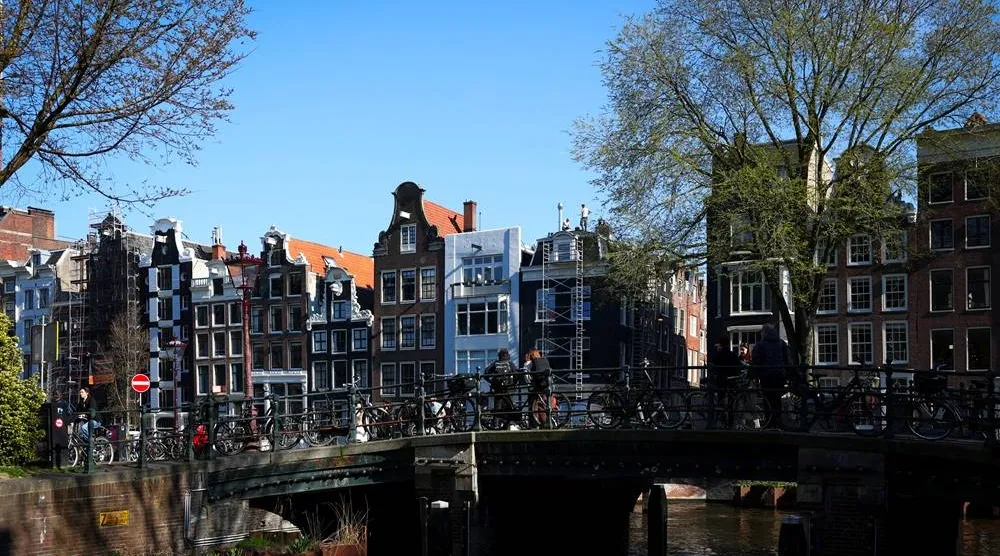 Typical Amsterdam houses sit next to a canal in Amsterdam, Netherlands, March 19, 2026. (Reuters) 