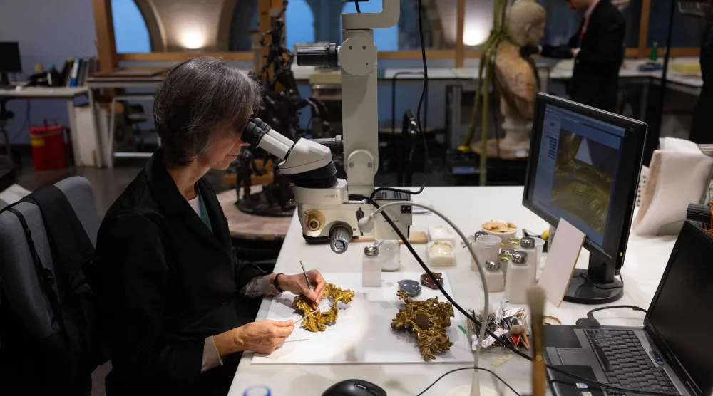 A conservator works on the restoration of gilded moldings at the Prado museum's sculpture restoration department in Madrid on October 23, 2025. (Pierre-Philippe Marcou/ AFP) 