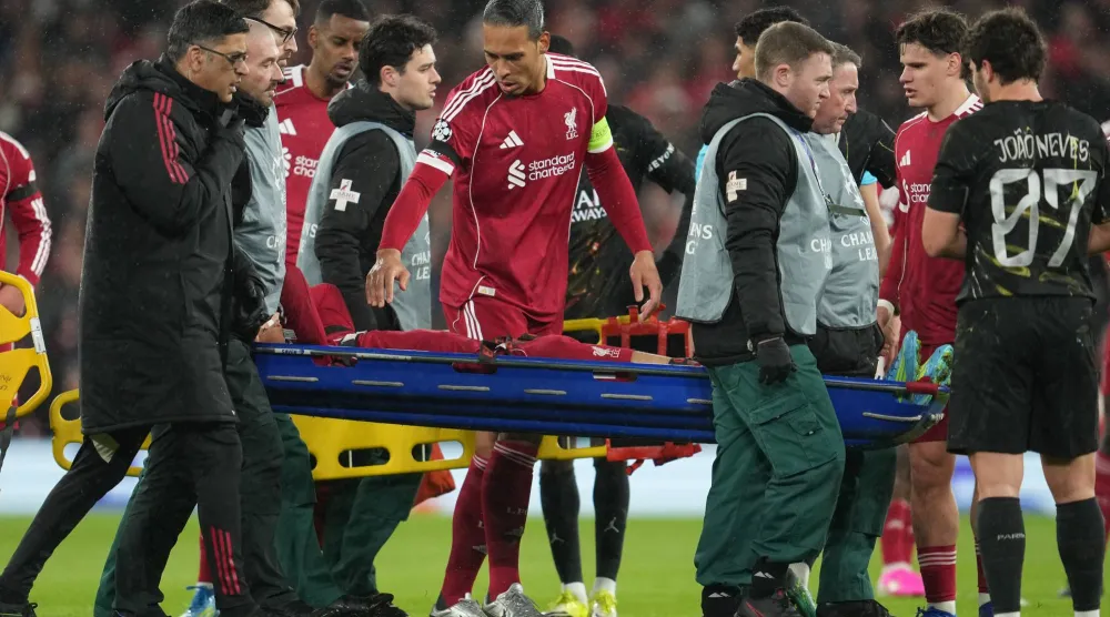 Liverpool's Virgil van Dijk checks on Hugo Ekitike during the Champions League quarterfinal second leg soccer match between Liverpool and Paris Saint-Germain in Liverpool, England, Tuesday, April 14, 2026. (AP Photo/Jon Super) 