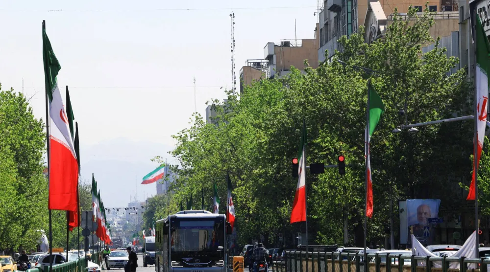 A street lined with Iranian flags in Tehran, Iran, April 16, 2026. REUTERS/Thaier Al-Sudani  