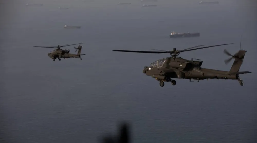 This handout photo released by US Central Command via their X account (@CENTCOM) on April 18, 2026 shows AH-64 Apaches flying above the Strait of Hormuz during a patrol on April 17, 2026. (US Central Command (CENTCOM) / AFP) 
