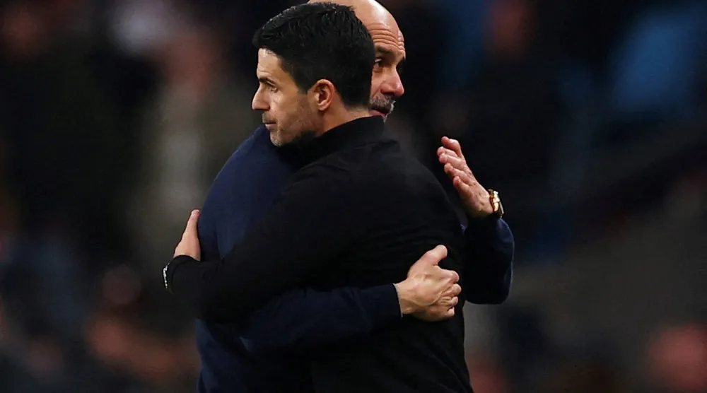 Football - Carabao Cup - Final - Arsenal v Manchester City - Wembley Stadium, London, Britain - March 22, 2026 Manchester City manager Pep Guardiola embraces Arsenal manager Mikel Arteta after winning the Carabao Cup. (Action Images via Reuters) 