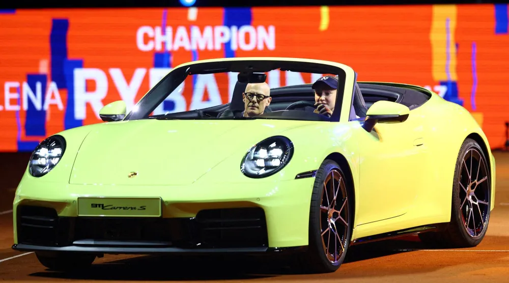 يلينا ريباكينا تقود سيارة بورشه وهي الجائزة التي تُسلَّم للفائز بلقب دورة شتوتغارت (أ.ب)