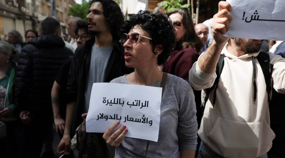 سيدة سورية تشارك في تظاهرة "الحقوق والكرامة" المطالبة بتحسين الاوضاع المعيشية، في ساحة يوسف العظمة وسط دمشق في 17 أبريل (رويترز)