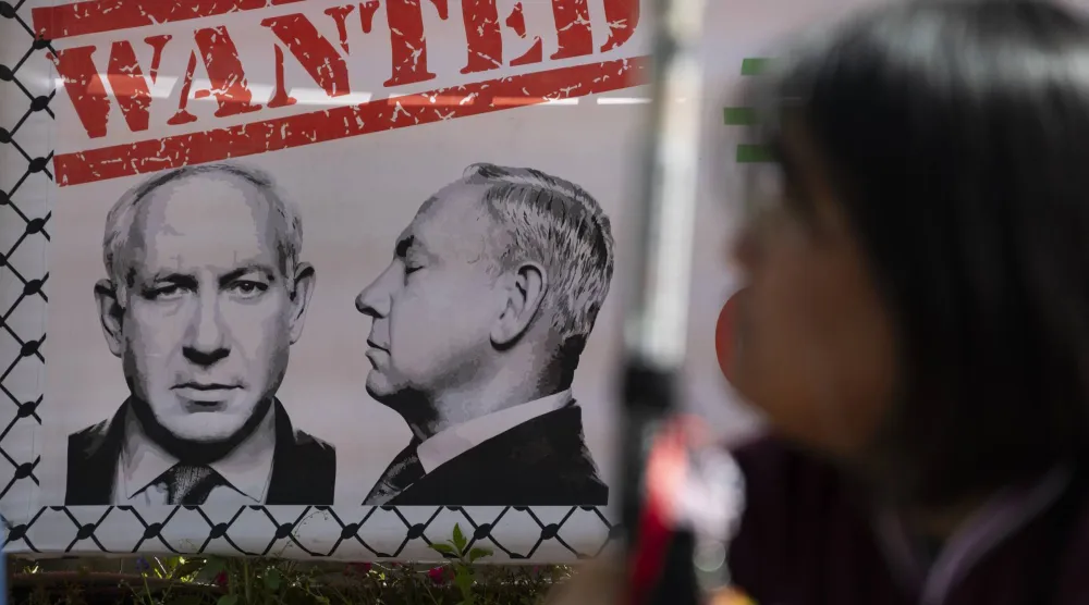 لافتة تحمل صورة لرئيس الوزراء الإسرائيلي بنيامين نتنياهو خلال احتجاجات على الضربات الأميركية الإسرائيلية على إيران في سيول (إ.ب.أ) 