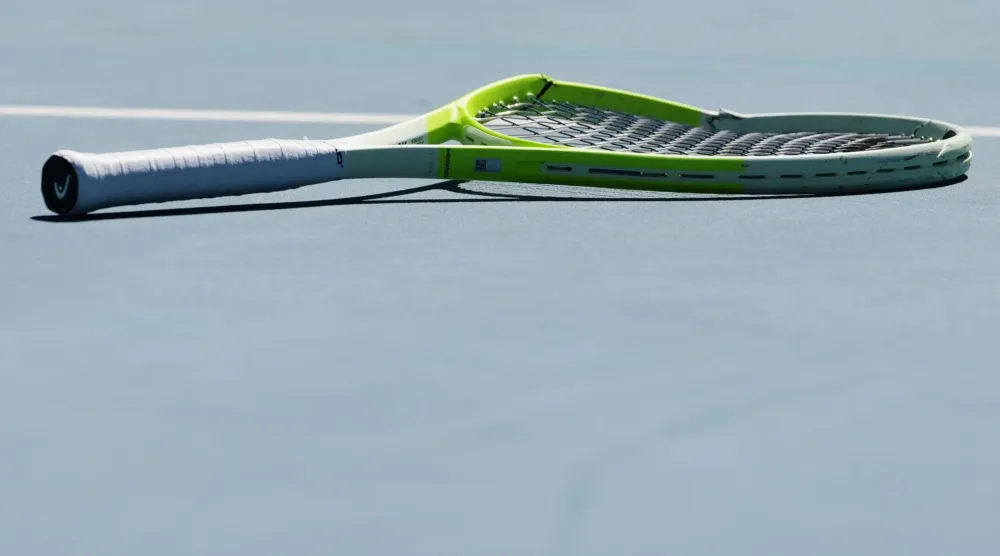 FILE - Alejandro Davidovich Fokina of Spain's racket lies on the court during his second round match against Reilly Opelka of the US at the Australian Open tennis championship in Melbourne, Australia, on Jan. 21, 2026. (AP Photo/Aaron Favila)