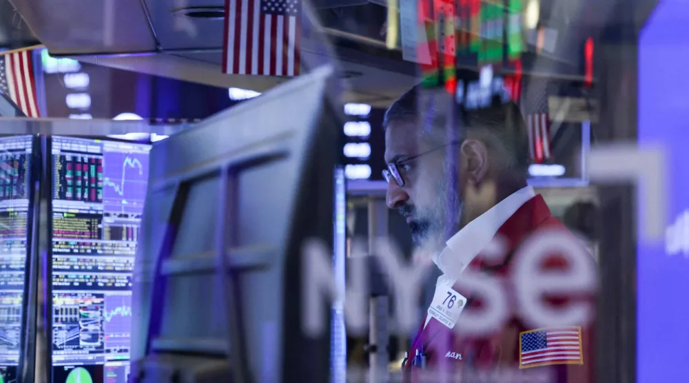 A trader works on the floor of the New York Stock Exchange (NYSE) at the opening bell in New York on March 24, 2026.  (Photo by ANGELA WEISS / AFP)