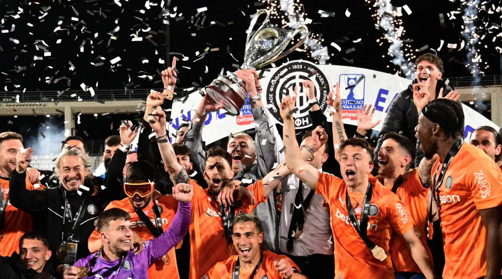 لاعبو أو إف آي كريت يحتفلون بالتتويج بكأس اليونان عقب فوزهم على باوك (رويترز)