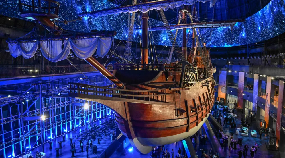 This photo taken on April 23, 2026 shows visitors under the Galeon Espiritu Santo, a full-scale representation of a 17th century galleon, on display at the Museo del Galeon in Manila. (Photo by Jam STA ROSA / AFP)
