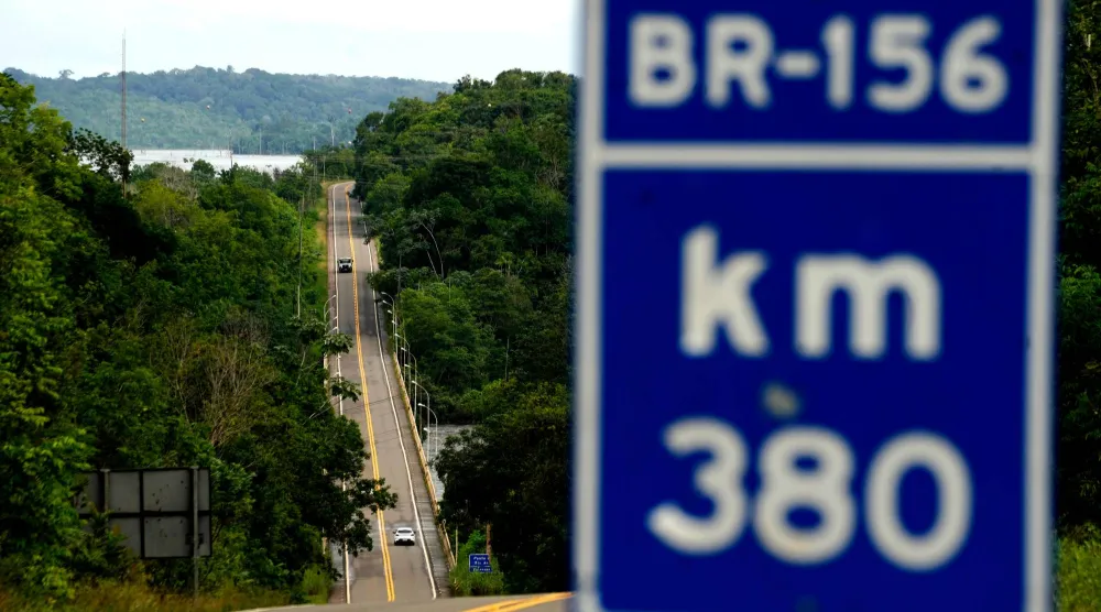 Vehicles drive on a fully paved section of BR-156 highway that connects the state capital Macapa with the city of Oiapoque, Amapa state, Brazil, Monday, March 9, 2026. (AP Photo/Eraldo Peres)