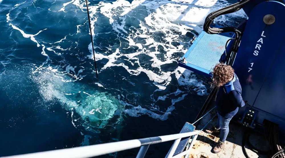 Marine Sadania, a maritime archaeologist in charge of scientific and heritage management for the PACA Coastal Observatory, observes the “ROV C 4000,” a remotely operated vehicle manufactured by the French company LD Travocean and designed for seabed exploration,  during its launch aboard the Jason (BSAA), chartered for an archaeological mission on the wreck of the CAMARAT 4 off the coast of Ramatuel, in southeastern France on April 7, 2026. (Photo by Thibaud MORITZ / AFP)