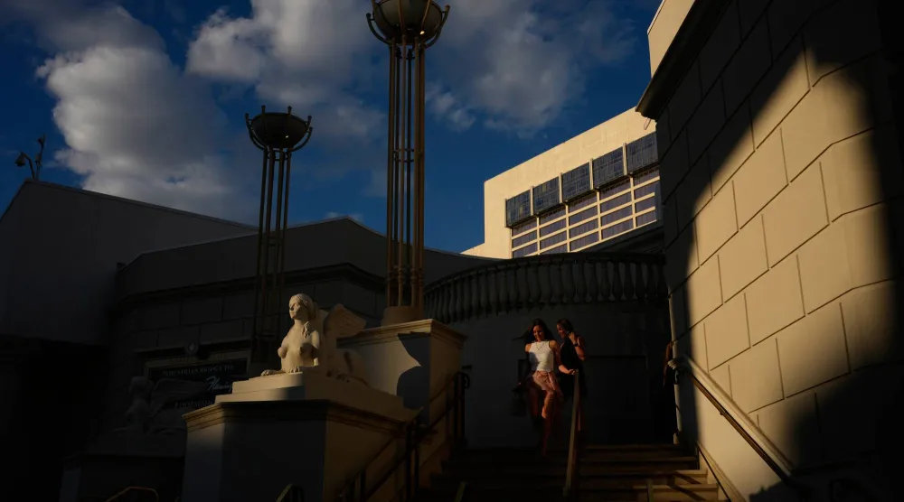 People walk near Caesars Palace along the Las Vegas Strip, Thursday, April 30, 2026, in Las Vegas, Nevada. (AP Photo/John Locher)