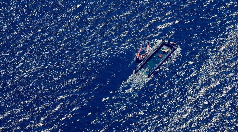 01 May 2026, Denmark, Skagen: An aerial view of the the humpback whale towed in its barge by the tugboat Fortuna B along the Danish coast, just south of Skagen in the Skagerrak, through the Baltic Sea. (dpa)