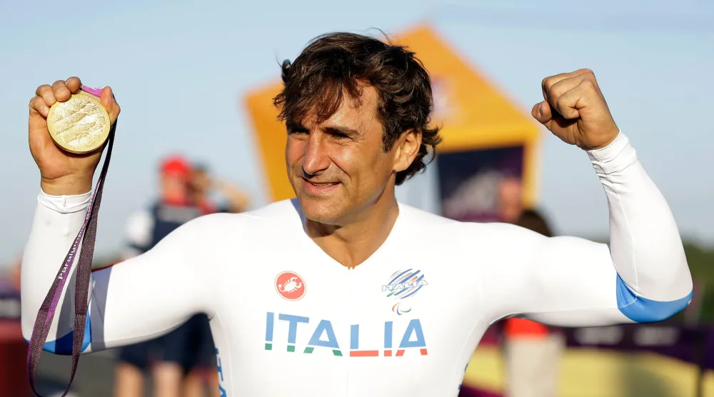 Alex Zanardi of Italy celebrates holding his gold medal following the medal ceremony for the man's road cycle individual time trial H4 category at the 2012 Paralympics games, Wednesday, Sept. 5, 2012, at Brands Hatch motor racing circuit near London. (AP)