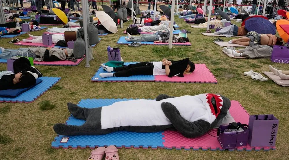  Participants take a nap during the 2026 Hangang Nap Competition at Yeouido Hangang Park in Seoul, South Korea, Saturday, May 2, 2026. (AP) 