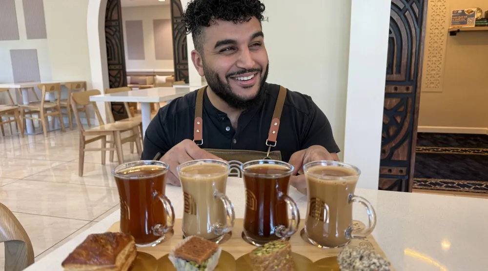 Franchisee Ahmad Badr serves a drink and treat sampler at Arwa Yemeni Coffee on April 6, 2026, in Sunnyvale, Calif. (AP) 