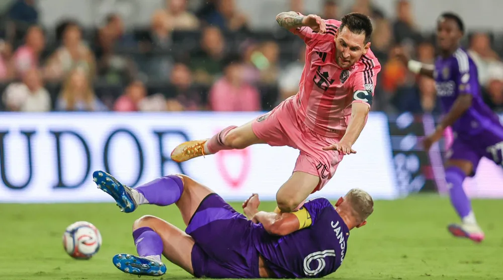 Inter Miami forward Lionel Messi (10) battles for the ball with Orlando City defender Robin Jansson (6) in the second half during an MLS soccer match, Saturday, May 2, 2026, in Miami. (AP Photo/Chris Arjoon).