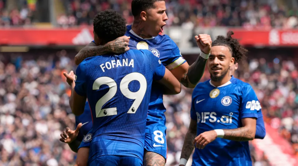 Chelsea's Enzo Fernandez (top) celebrates with team-mate Wesley Fofana after scoring their side's first goal of the game during the Premier League soccer match between Liverpool and Chelsea in Liverpool, England, Saturday, May 9, 2026. (Peter Byrne/PA via AP)