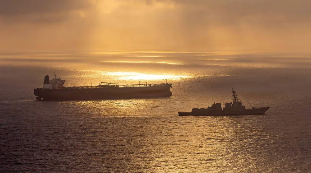 This US Navy handout photo released on May 8, 2026 by US Central Command Public Affairs, shows the Arleigh Burke-class guided-missile destroyer USS Rafael Peralta (DDG 115) implementing a maritime blockade against the Iran-flagged crude oil tanker vessel Herby while the latter was attempting to sail toward an Iranian port, on April 24, 2026. (Photo by US NAVY / AFP)  