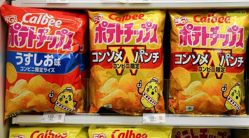 Bags of Calbee potato crisps are seen at a convenience store in Tokyo on May 12, 2026. (AFP)