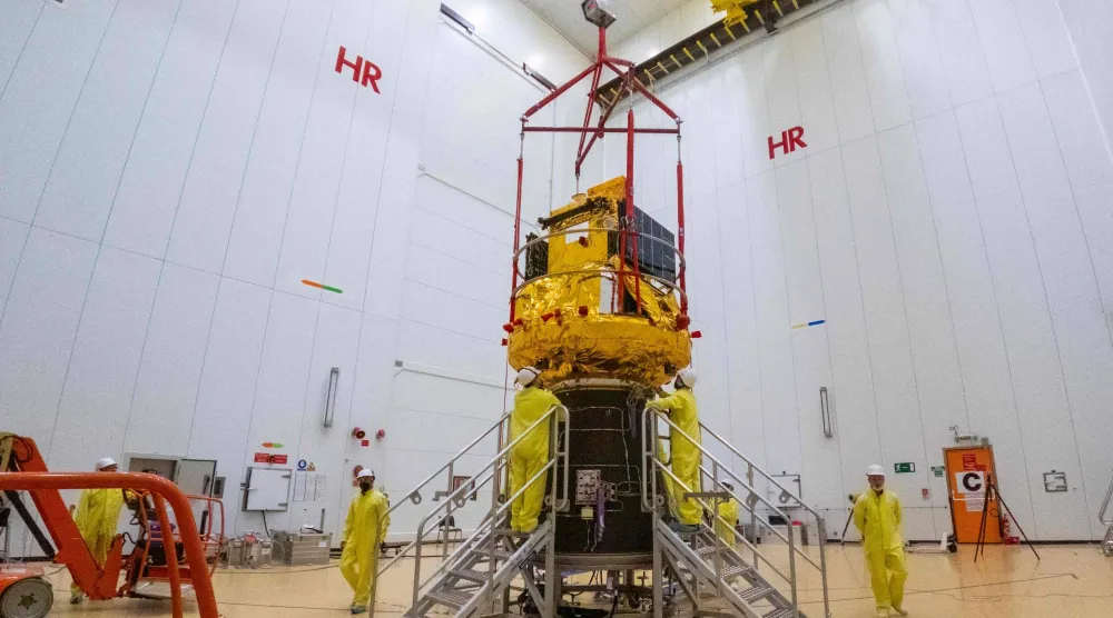 This photograph shows the Smile spacecraft (gold) fixed to a Vega-C rocket adaptor (black cone) on 25 March 2026, in Kourou, French Guiana, in preparation for liftoff from Europe's Spaceport. (Photo by ESA / AFP)