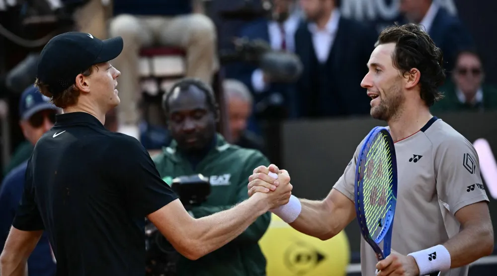 Italy's Jannik Sinner (L) shakes hands with Norway's Casper Ruud after winning the men's final of the ATP Rome Open tennis tournament at the Foro Italico in Rome on May 17, 2026. (Photo by Filippo MONTEFORTE / AFP)
