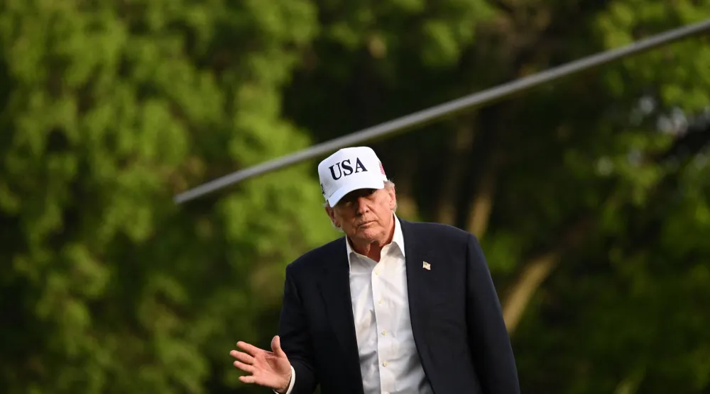 US President Donald Trump waves after stepping off Marine One on the South Lawn of the White House in Washington, DC, on May 15, 2026. (Photo by Alex WROBLEWSKI / AFP)