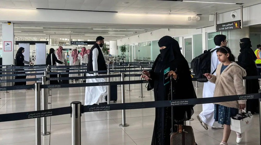 Travelers move through stanchion lines at the departure terminal of King Khalid International Airport in Riyadh. (AFP)