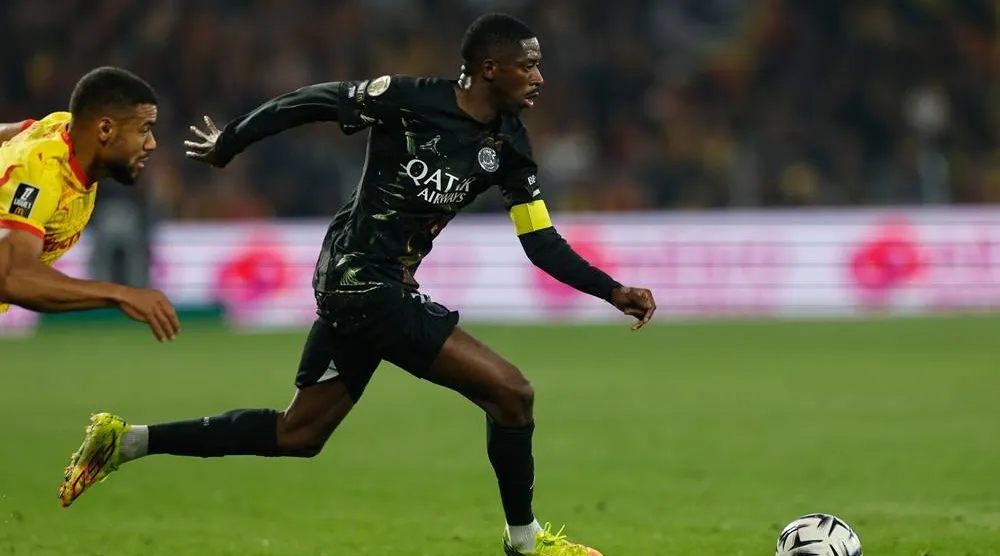 PSG's Ousmane Dembele runs with the ball during the French League One soccer match between Lens and Paris Saint Germain, in Lens, northern France, Wednesday, May 13, 2026. (AP)