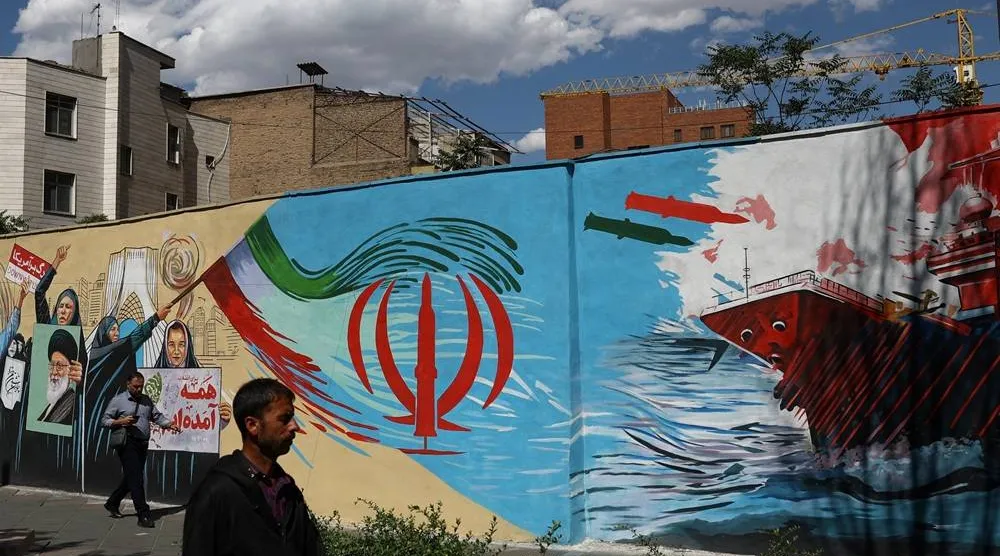 People walk on a street near a mural featuring an image of the late Supreme Leader of Iran, Ali Khamenei, in Tehran, Iran, May 18, 2026. Majid Asgaripour/WANA (West Asia News Agency) via Reuters