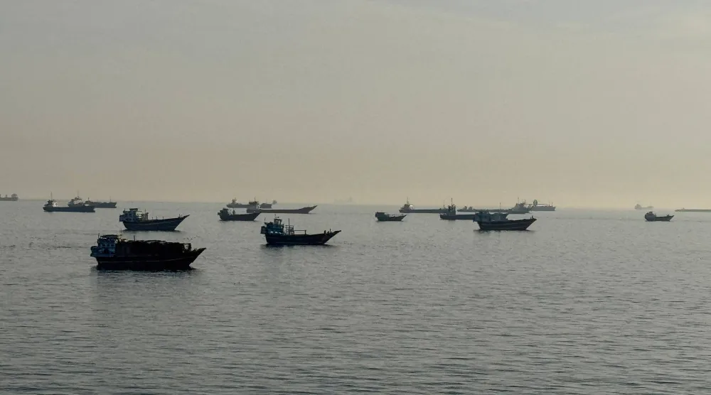 Vessels are seen anchored in the Strait of Hormuz, off the port city of Khasab on Oman's northern Musandam Peninsula on May 17, 2026. (AFP)