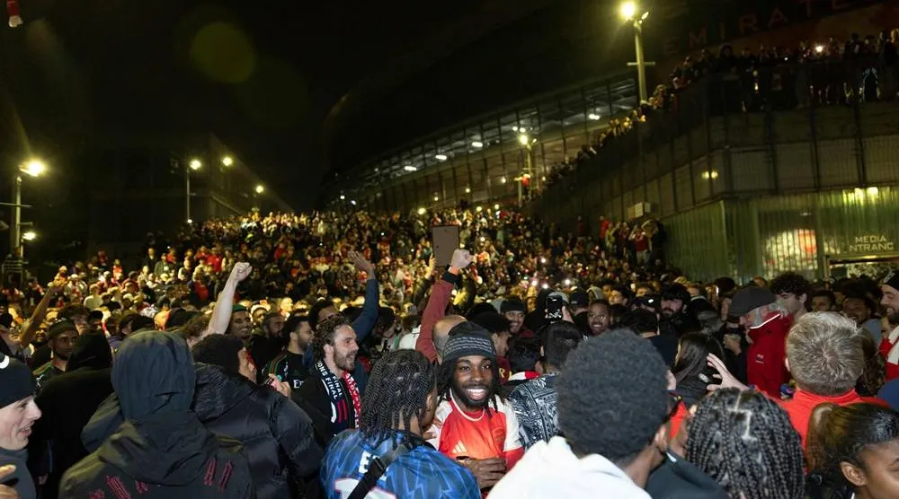 Arsenal fans celebrate their team winning the English Premier League, outside the Emirates Stadium in London on May 20, 2026. (AFP)