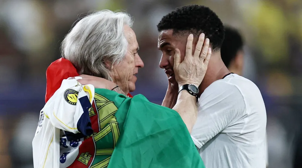 خيسوس يهنئ لاعبه أنجيلو بعد تحقيق لقب «الدوري السعودي» (رويترز)