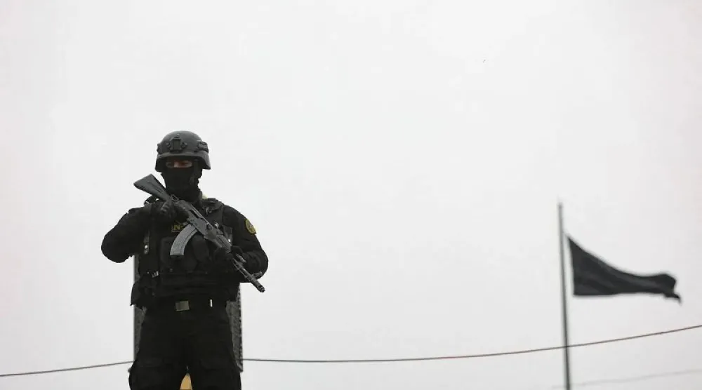 A security personnel stands guard as Iranians take part in a protest marking the annual al-Quds Day (Jerusalem Day) on the last Friday of the holy month of Ramadan, amid the US-Israeli conflict with Iran, in Tehran, Iran, March 13, 2026. Majid Asgaripour/WANA (West Asia News Agency) via Reuters
