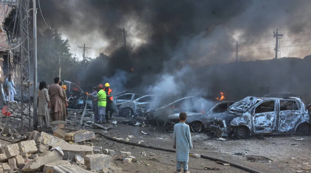 Firefighters work to extinguish the burning cars at the site of bomb explosion, in Quetta, Pakistan, Sunday, May 24, 2026. (AP Photo/Arshad Butt)