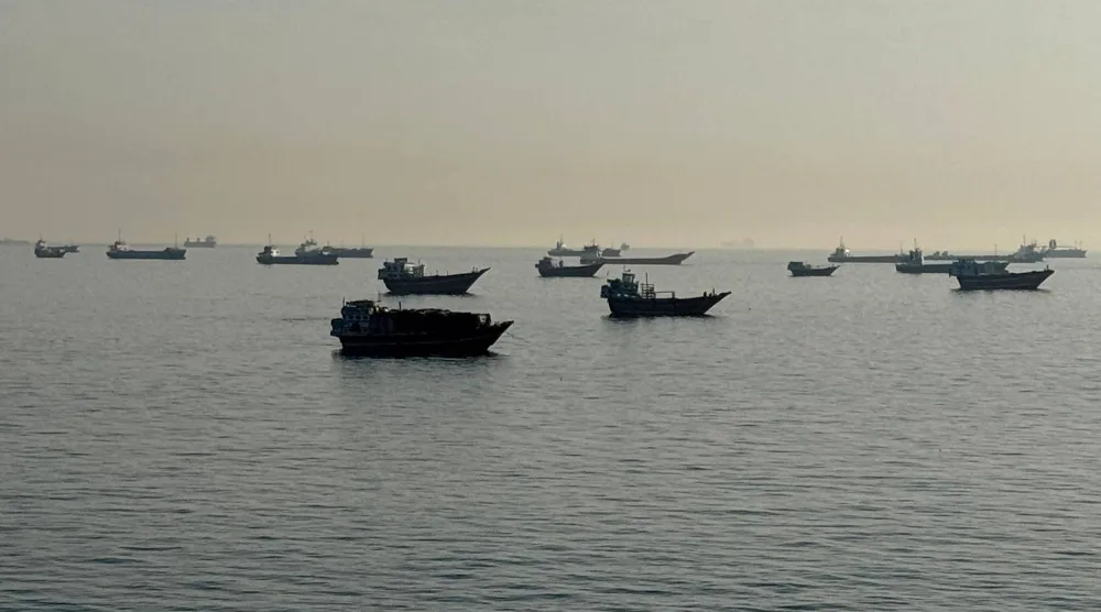 Vessels are seen anchored in the Strait of Hormuz, off the port city of Khasab on Oman's northern Musandam Peninsula on May 17, 2026. (AFP)