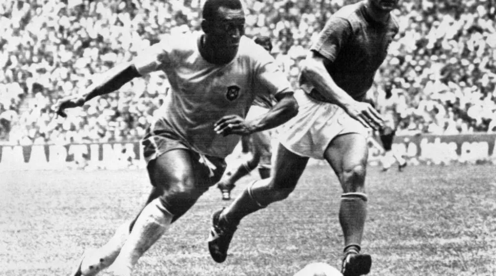 البرازيلي بيليه يتخطى المدافع الإيطالي تارتشيزيو بورنييك في نهائي مونديال 1970 (أ.ف.ب)