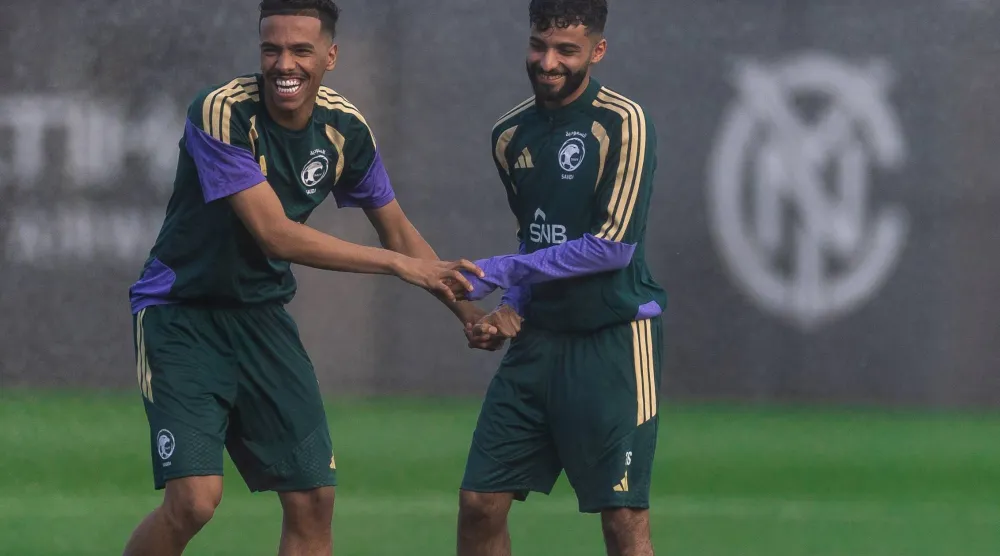 الجوير يمازح زميله أبو الشامات خلال المعسكر (المنتخب السعودي)