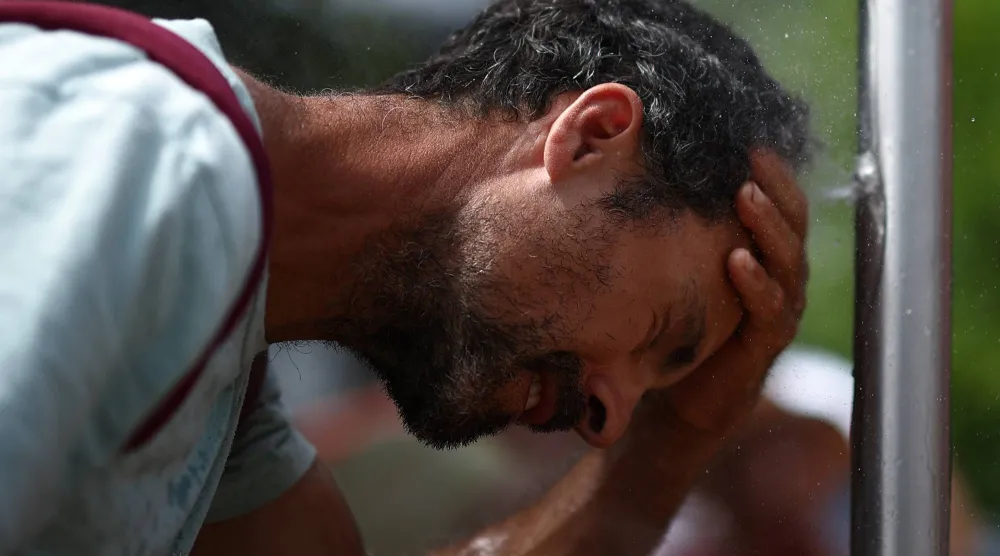  Tennis - French Open - Roland Garros, Paris, France - May 29, 2026 A spectator uses a tap outside the courts during the matches. (Reuters)