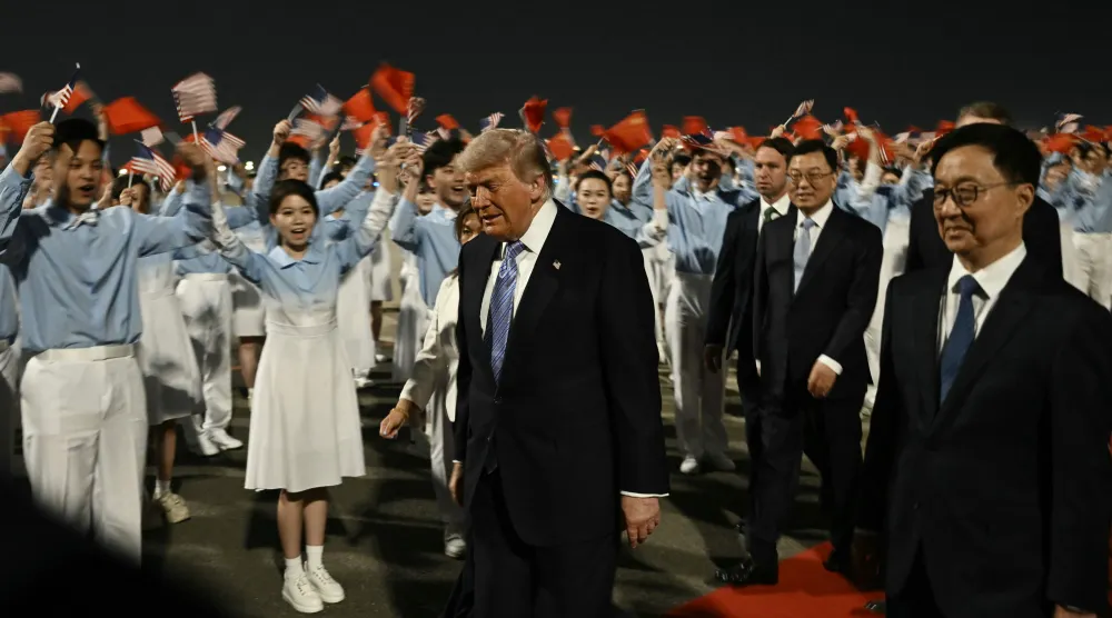 US President Donald Trump (C) is escorted by China's Vice President Han Zheng (R) upon his arrival at Beijing Capital Airport in Beijing on May 13, 2026. (AFP)