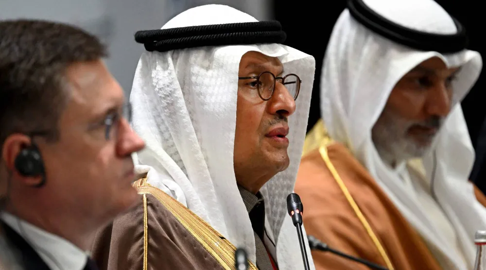 عبد العزيز بن سلمان متوسطاً نوفاك (إلى يمنيه) والغيص خلال جلسة بمنتدى سانت بطرسبرغ (أ.ف.ب)