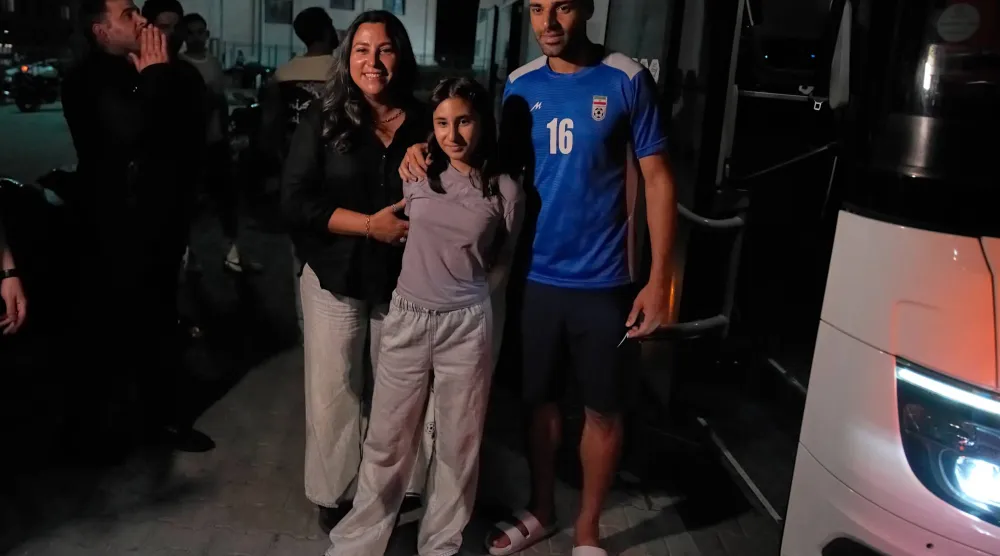 Iran's Mehdi Torabi, right, poses for a photo with fans after a friendly soccer match between Iran and Mali, in Antalya, southern Türkiye, Thursday, June 4, 2026, ahead of the World Cup soccer tournament. (AP Photo/Khalil Hamra)