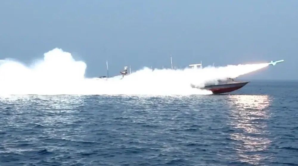 This handout photo released by Iran’s Revolutionary Guards Corps (IRGC)’s official website Sepanews on February 17, 2026, shows a rocket being fired from a boat during a military exercise by members of the IRGC and navy in the Strait of Hormuz via AFP