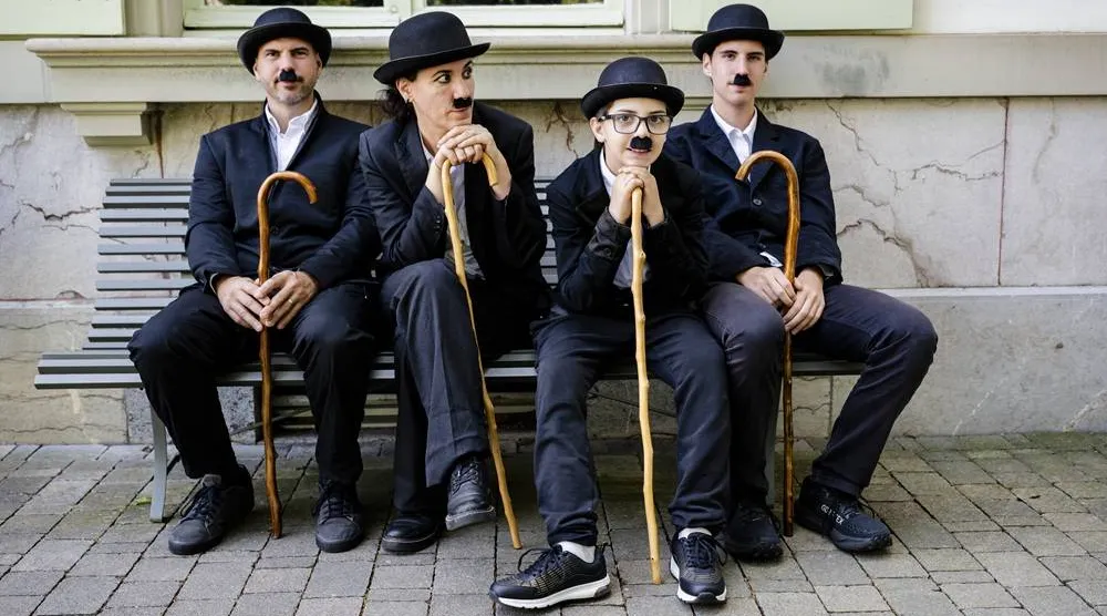 Some of the 429 people dressed as "The Tramp" pose for a photo during the 10th anniversary of Chaplin's World, the museum dedicated to the life of Charlie Chaplin, in Corsier-sur-Vevey, Switzerland, 07 June 2026. (EPA)