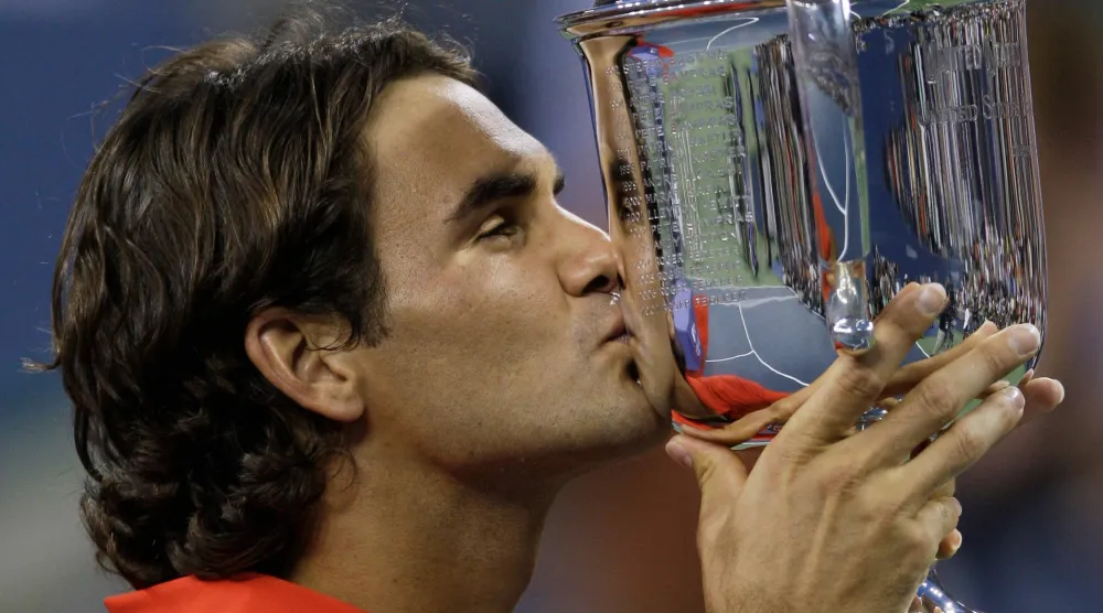Roger Federer, of Switzerland, kisses the championship trophy after winning the men's finals championship over Andy Murray, of Britain, at the US Open tennis tournament in New York, Monday, Sept. 8, 2008. (AP) 