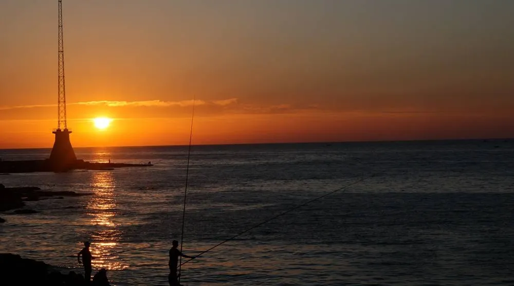 People fish at sunset near the Corniche Al-Manara seafront promenade on the Mediterranean coast in Beirut, Lebanon, 05 June 2026. (EPA)