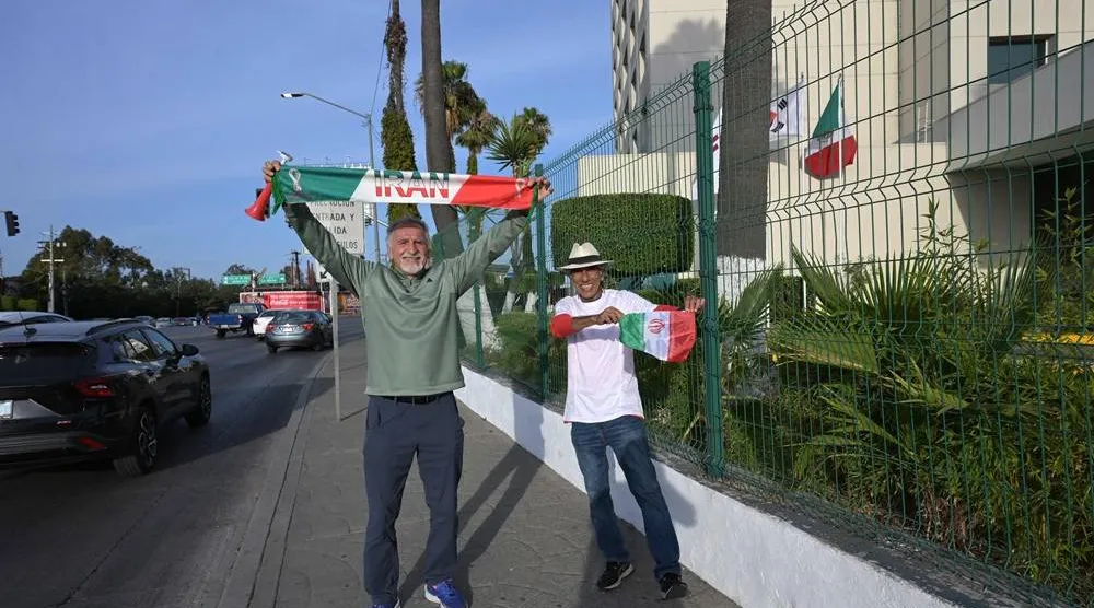  Reza Mansoori (R) and Mostafa Pourmanda, Iranian supporters living in San Diego and staying at the same hotel as Iran's national football team, cheer for their team in Tijuana, Mexico, on June 8, 2026, ahead of the FIFA 2026 World Cup football tournament. (AFP) 
