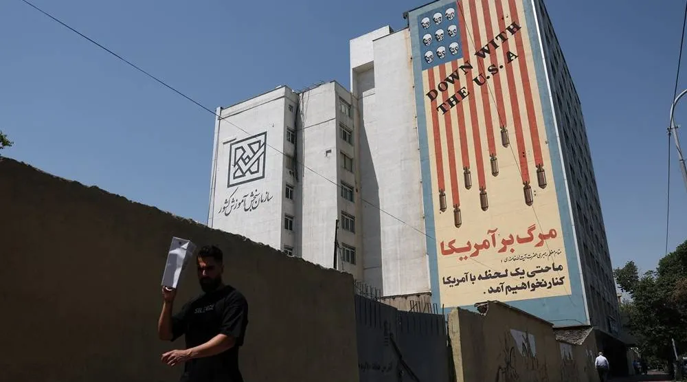A man walks near an anti-US mural on a building in Tehran, Iran, June 9, 2026. Majid Asgaripour/WANA (West Asia News Agency) via Reuters