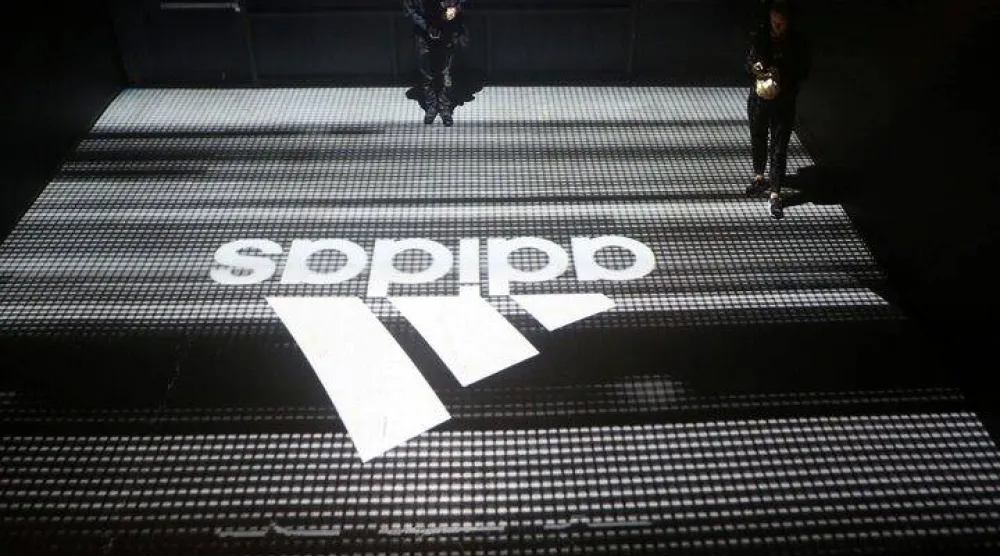FILE PHOTO: An Adidas logo is seen at the new Futurecraft shoe unveiling event in New York City, New York, US April 6, 2017. REUTERS/Joe Penney/File Photo 