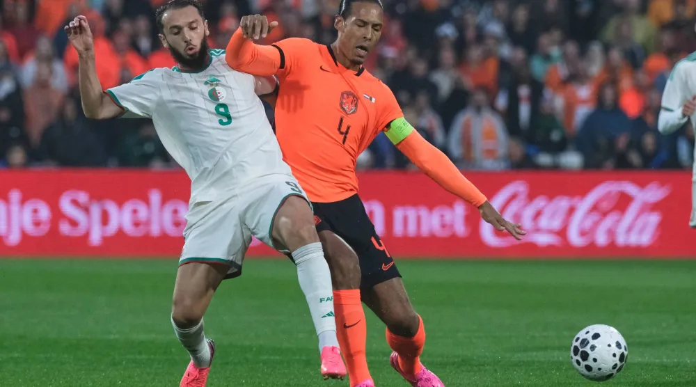 Algeria's Amine Gouiri, left, challenges for the ball with Netherlands' Virgil van Dijk during the international friendly soccer match between Netherlands and Algeria in Rotterdam, Netherlands, Wednesday, June 3, 2026. (AP Photo/ Patrick Post)
